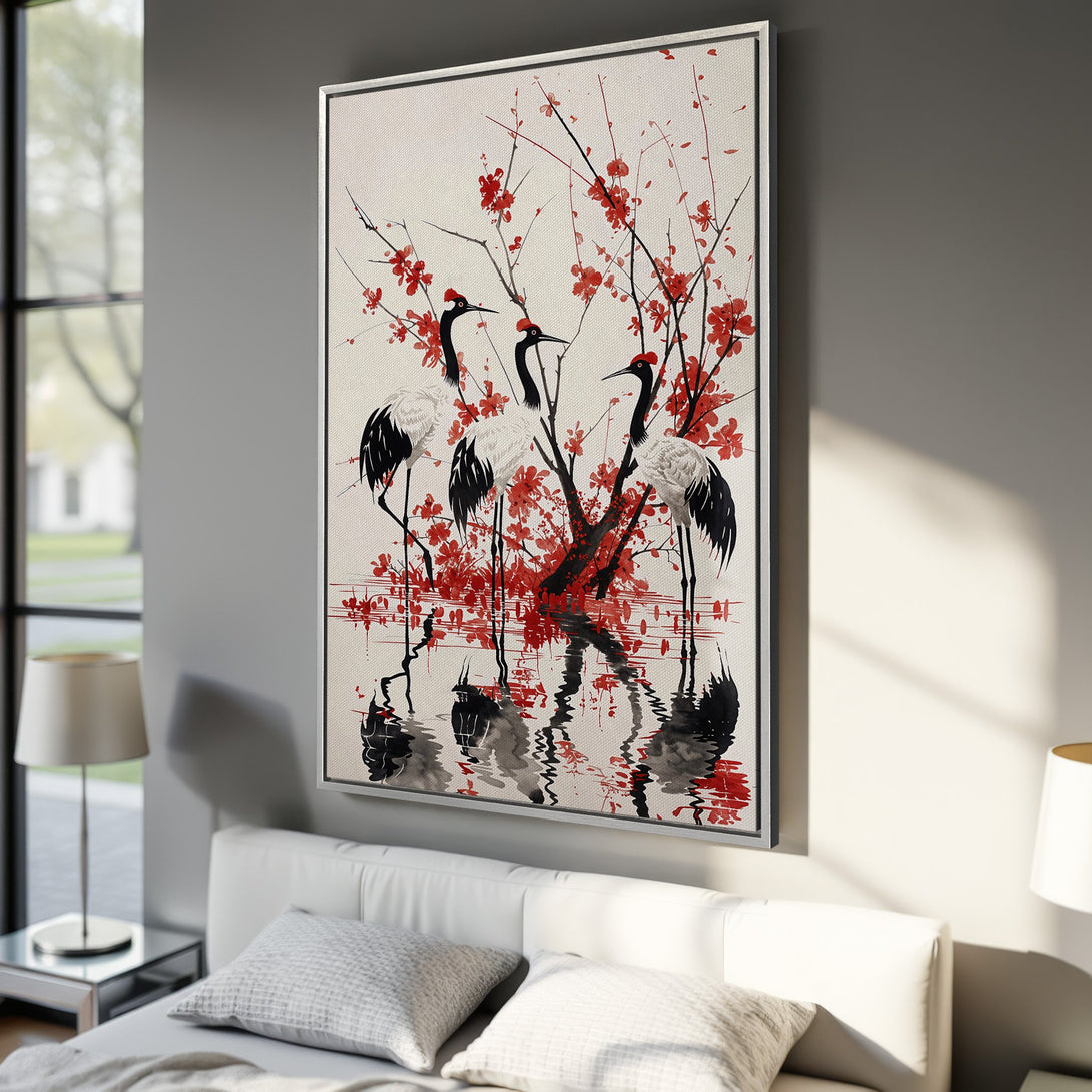 Framed Wall Art featuring elegant cranes and red blossoms in a serene, Asian-inspired style. A beautiful addition to any interior, with a calming red, black, and white palette.