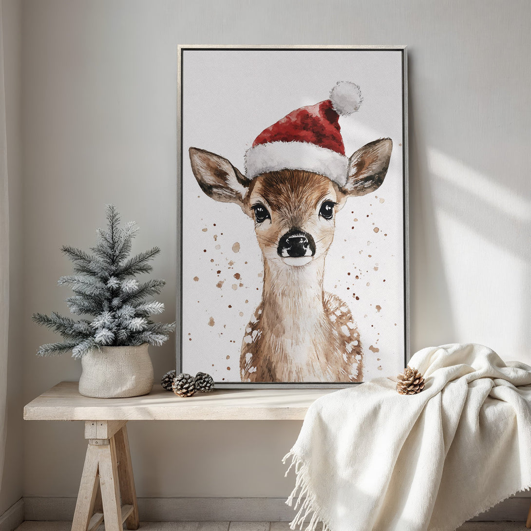Framed Wall Art: Watercolor deer in a Santa hat. Neutral color palette with pops of red. Perfect Christmas decor for a cozy interior.