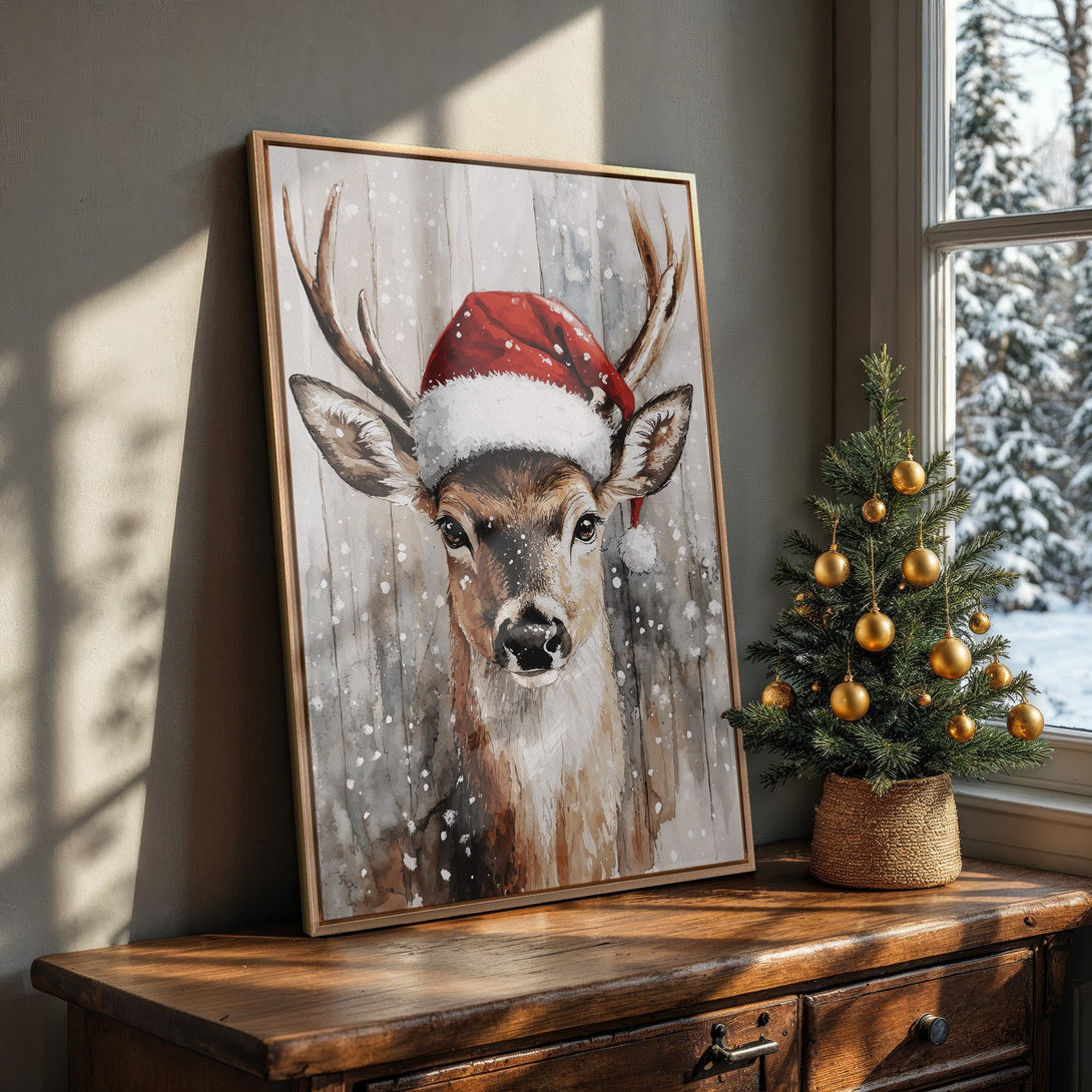 Framed Wall Art: Watercolor deer wearing Santa hat. Rustic style with brown, grey, and red color palette. Festive holiday decor for your home.