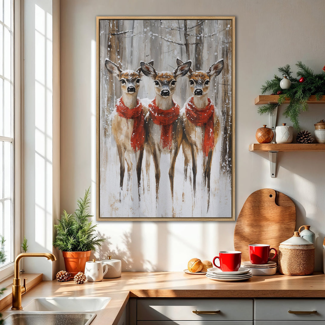 Framed Wall Art featuring three deer in a snowy forest, wearing red scarves. Rustic style with a warm, neutral color palette. Perfect for winter decor!