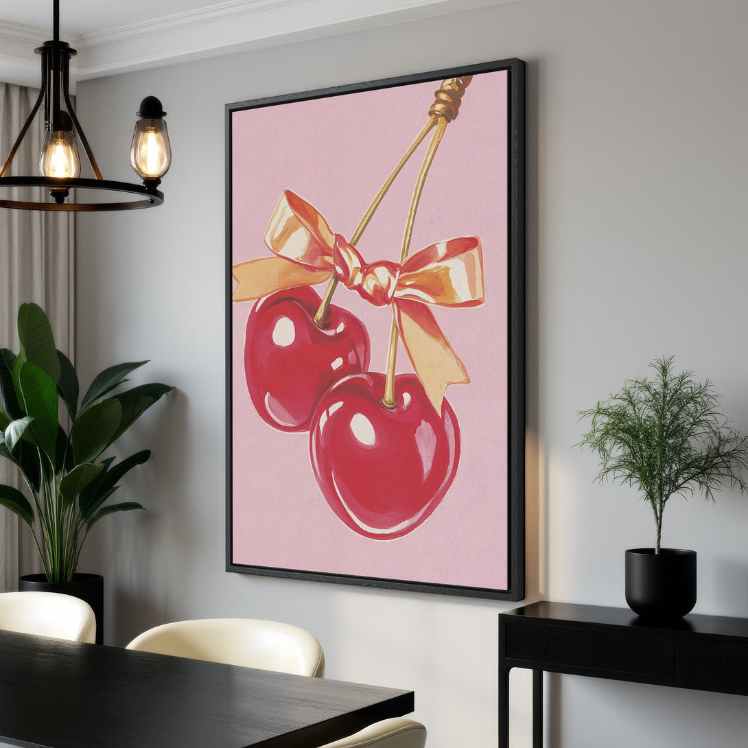 Framed Wall Art featuring watercolor cherries on pink background. Modern, vibrant canvas print perfect for kitchen or dining room decor. Shop now!
