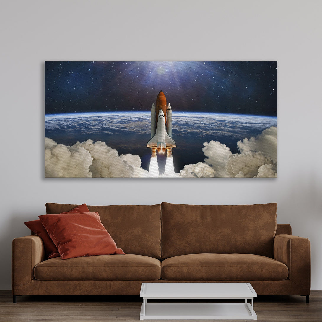Framed Wall Art: Space shuttle launch canvas print in a warm-toned interior. Featuring a vibrant space scene with a blue, orange, and white color palette. Elevate your home decor!
