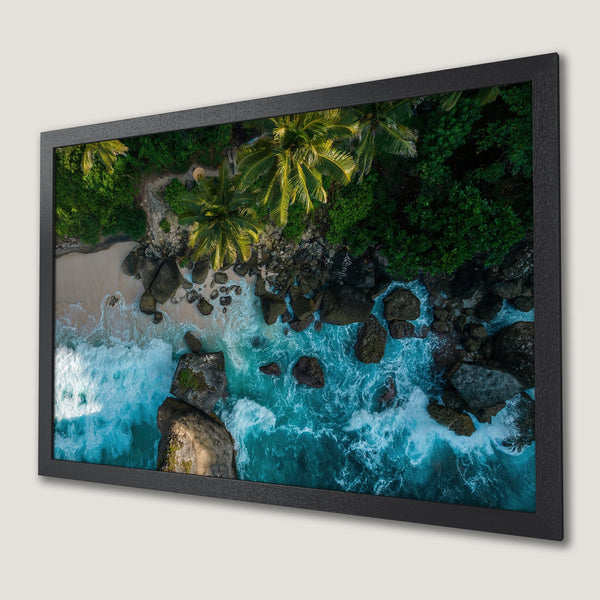 Framed Poster of a tropical beach scene with turquoise water, green palm trees, and a dramatic, aerial view. Coastal decor.
