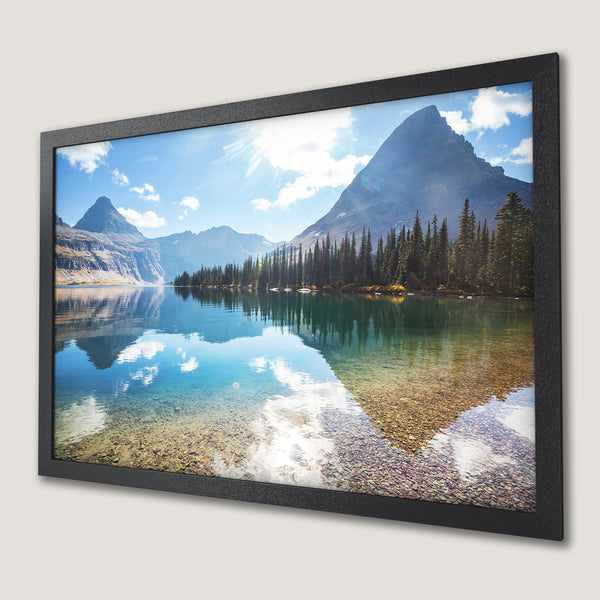Framed Poster of a serene lake scene with mountains, trees, and blue sky. Nature-inspired art in cool, calming tones.