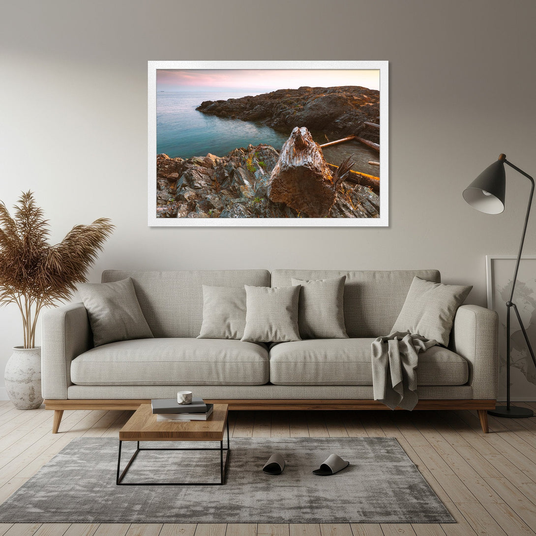 Framed Poster featuring a coastal landscape. Serene, natural style with a muted blue, brown, and pink color palette. Perfect for adding a touch of nature.