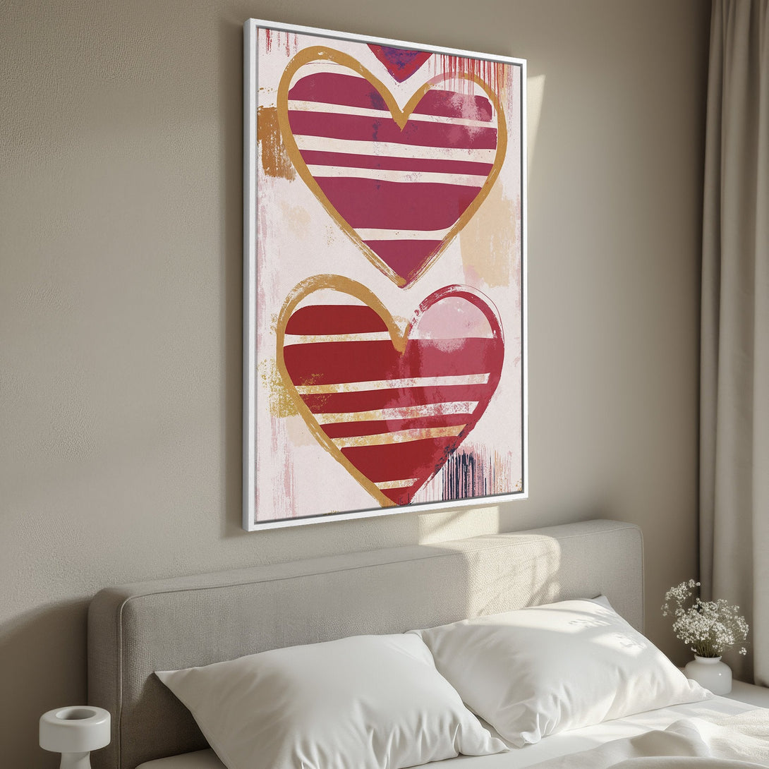 Framed Wall Art featuring abstract hearts in red and gold, displayed in a bedroom. Modern art with a warm, romantic color palette.