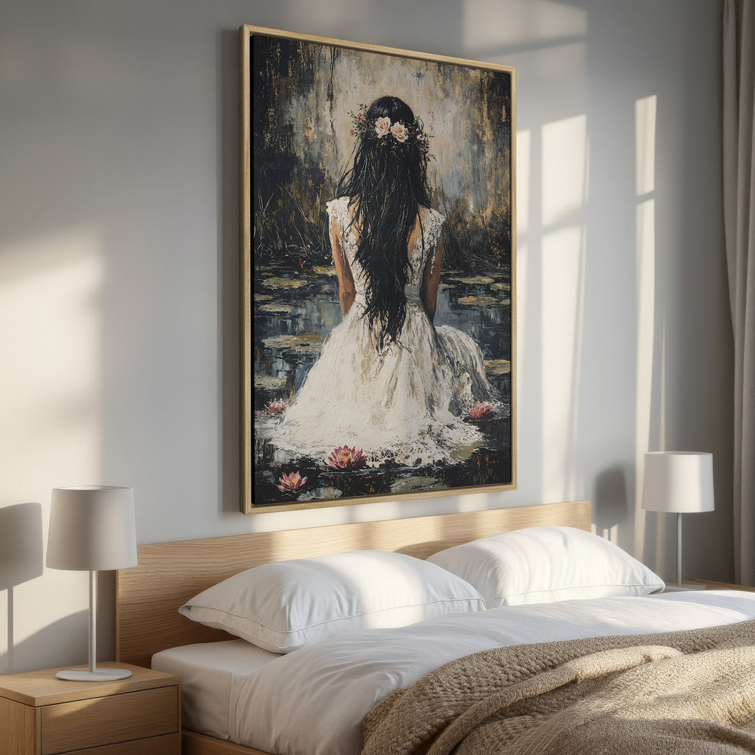 Framed Wall Art featuring a woman in a white dress, floral crown, & dark hair, set in a serene, moody scene with a muted color palette. Perfect for bedroom decor.