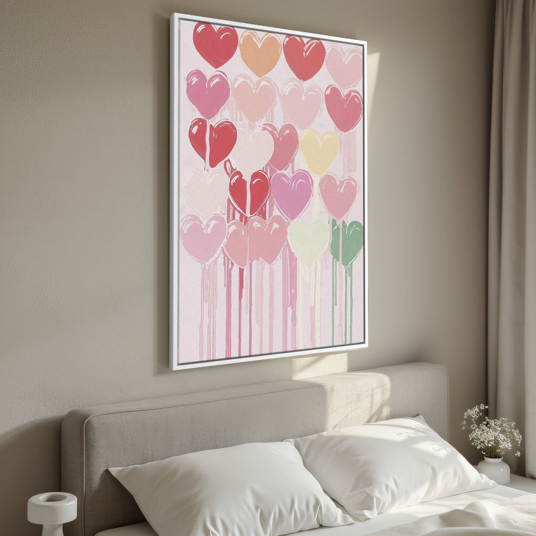 Framed Wall Art: Colorful heart canvas print in a bedroom. Modern abstract art with a pink, red, and pastel palette. Perfect for Valentine's decor.