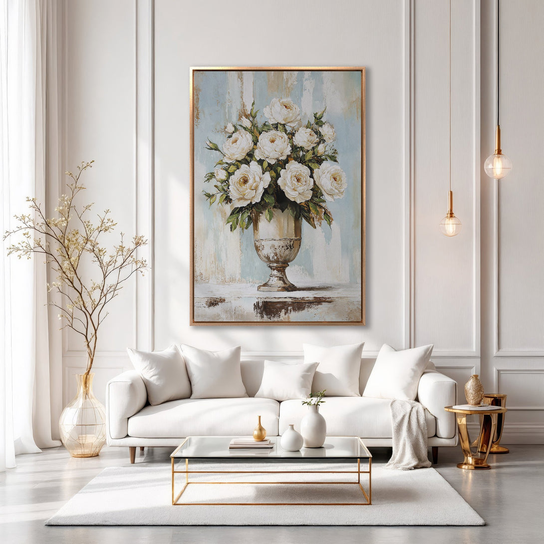 Framed Wall Art featuring a floral still life in a gold frame, displayed in a chic, modern living room with a soft, neutral color palette.