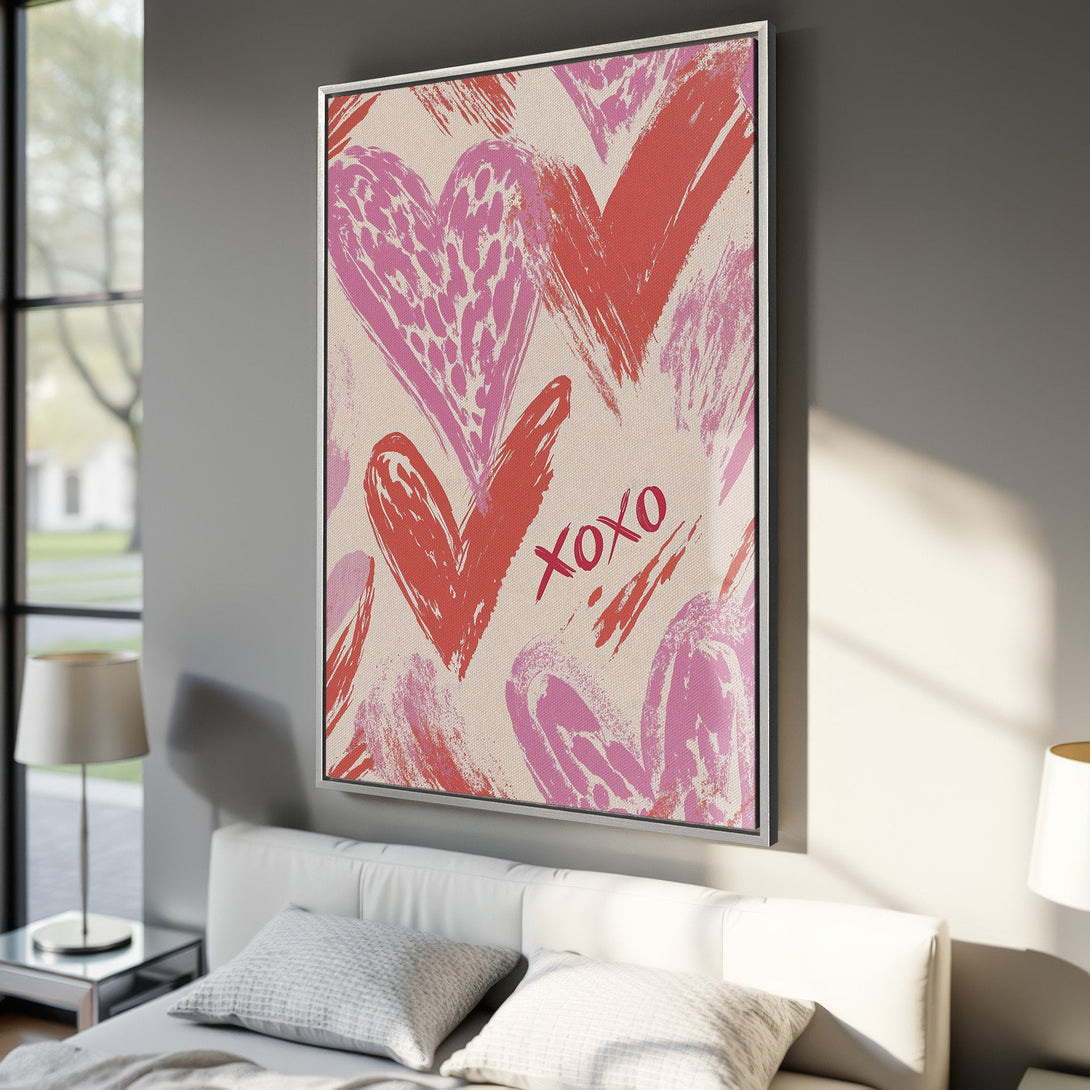 Framed Wall Art featuring abstract hearts in pink and red. Modern brushstroke style perfect for Valentine's Day decor. Adds a pop of color to any bedroom.