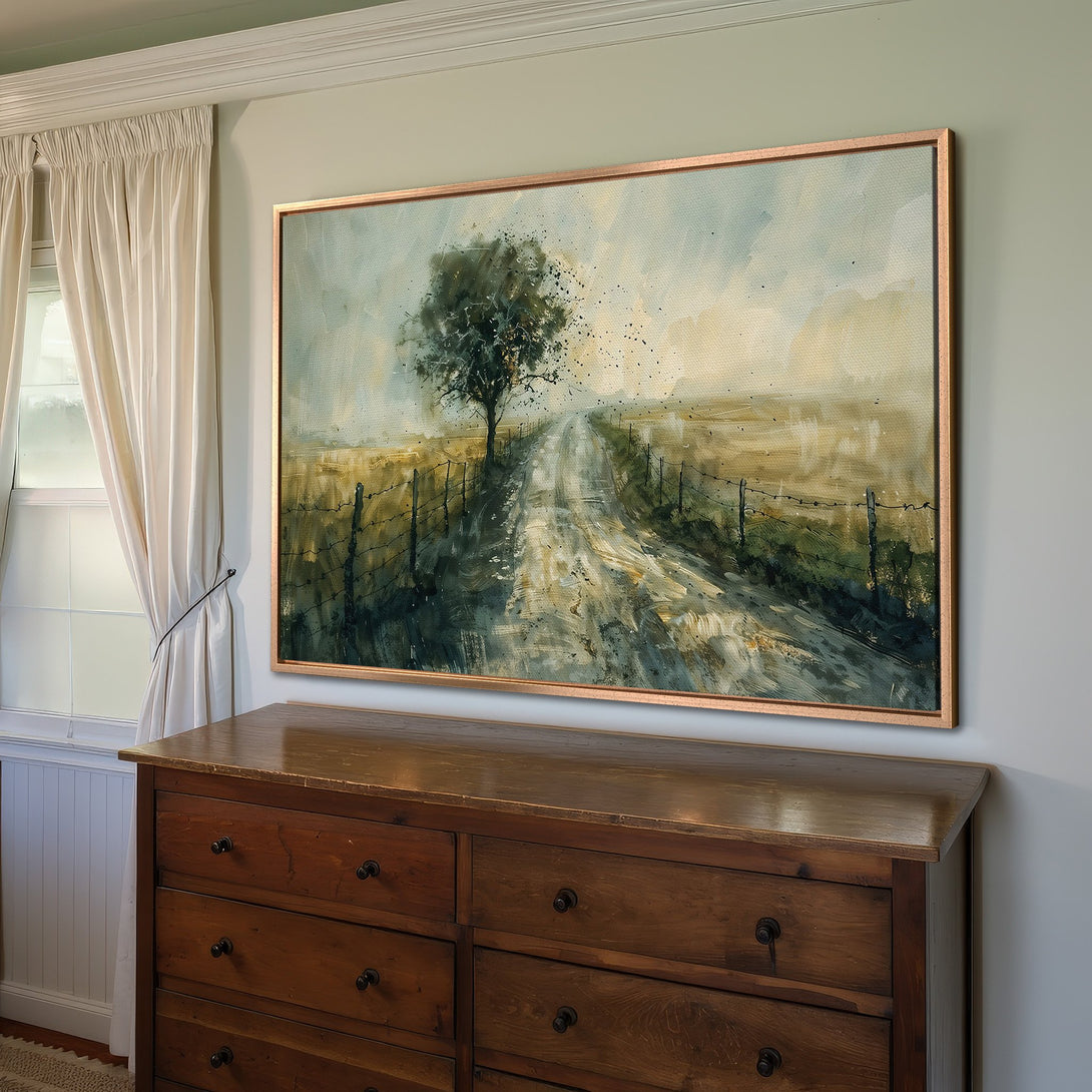 Framed Wall Art: Watercolor landscape Canvas Print. Features a rural road scene with a tree. Earthy tones of green, brown, and gold create a serene aesthetic.