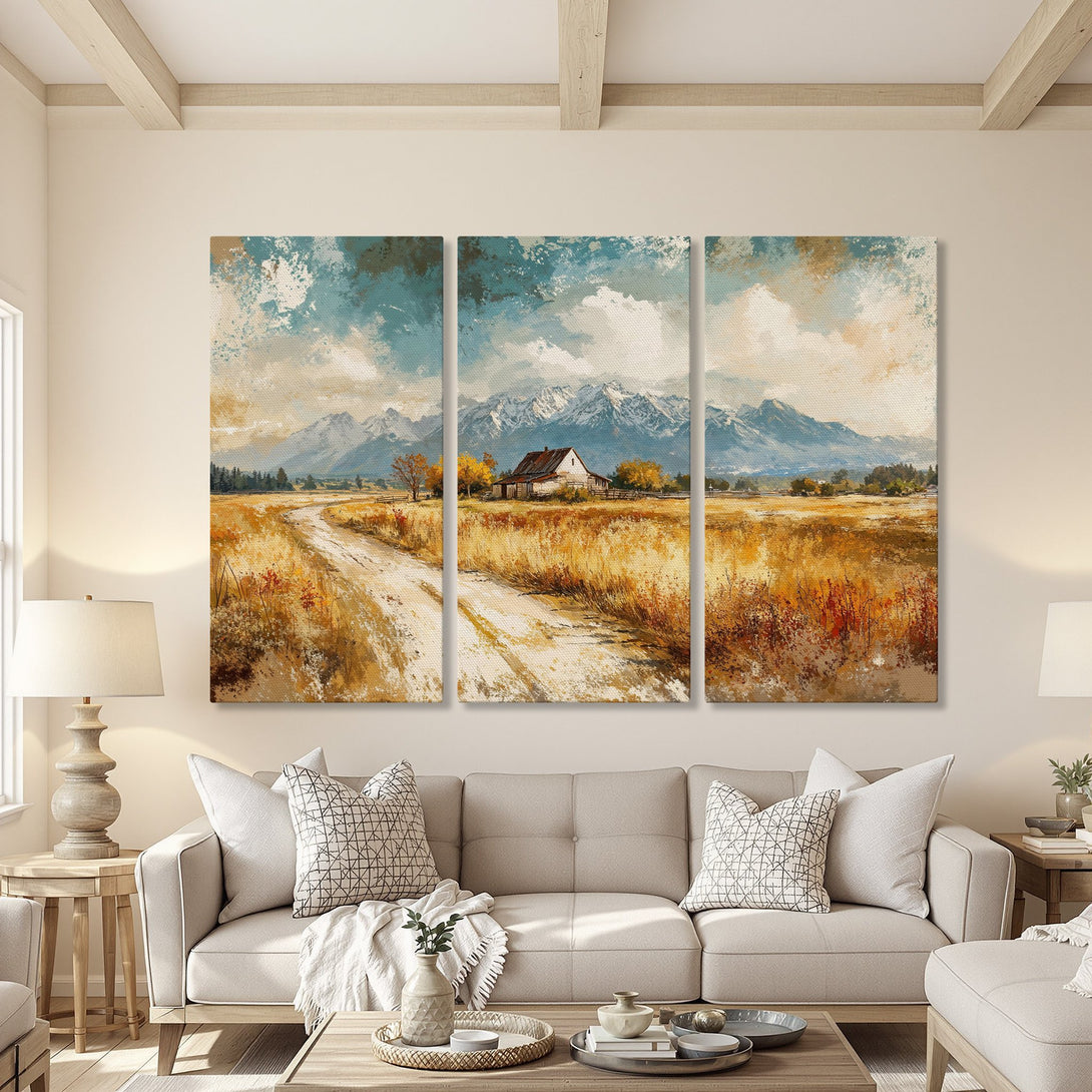 Canvas Print of a serene landscape with mountains, road, and farmhouse. Warm color palette with blue sky and golden fields, perfect for home decor.