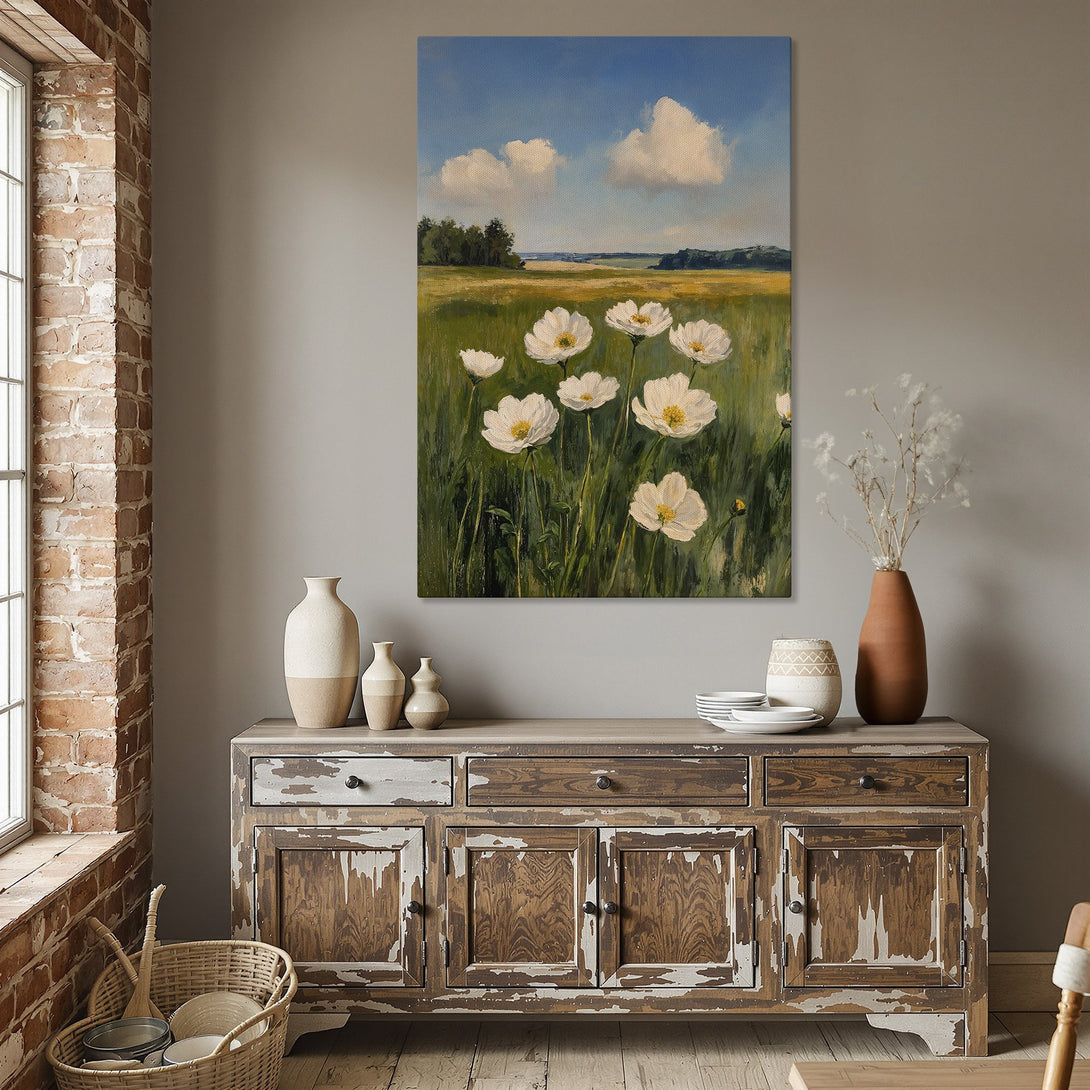 Framed Wall Art: Impressionist painting of white flowers in a field, blue sky, and gold frame. Adds a touch of nature to any room.