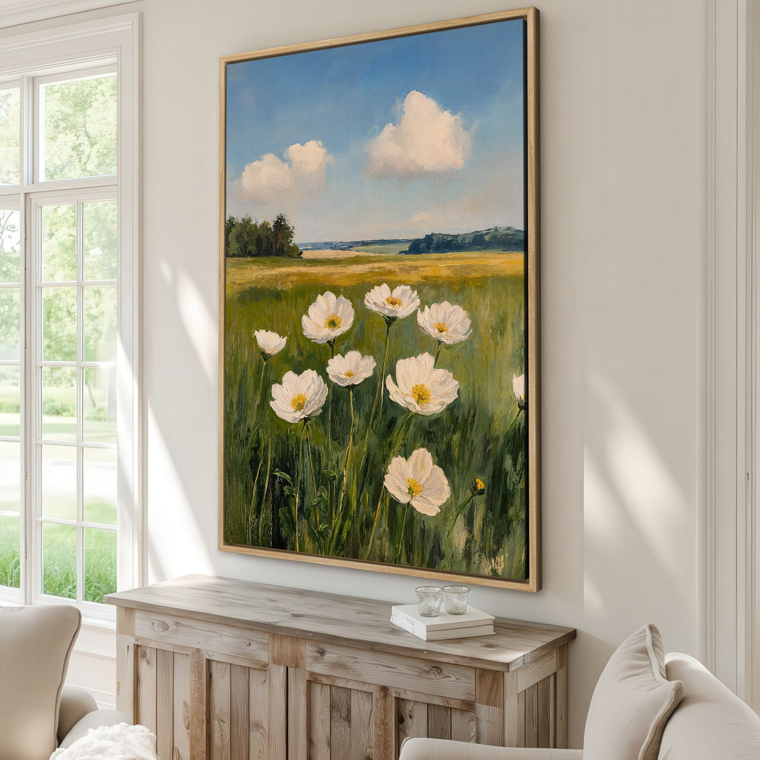 Framed Wall Art: Impressionistic landscape painting of white flowers in a field, with a blue sky. Soft green, yellow, and white color palette. Perfect home decor.