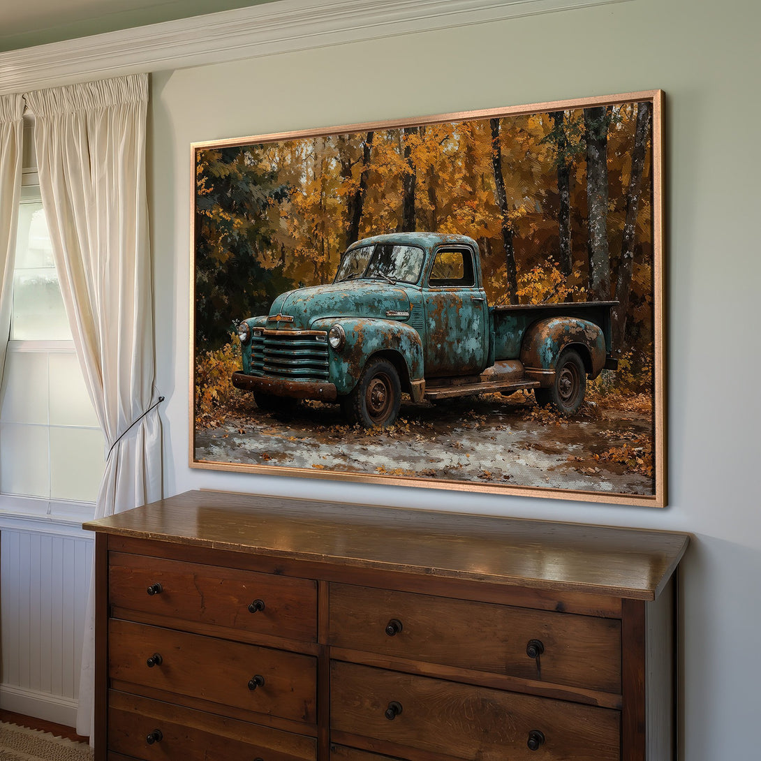 Framed Wall Art featuring a vintage teal truck in an autumn forest scene. Rustic, warm color palette. Perfect for farmhouse decor.