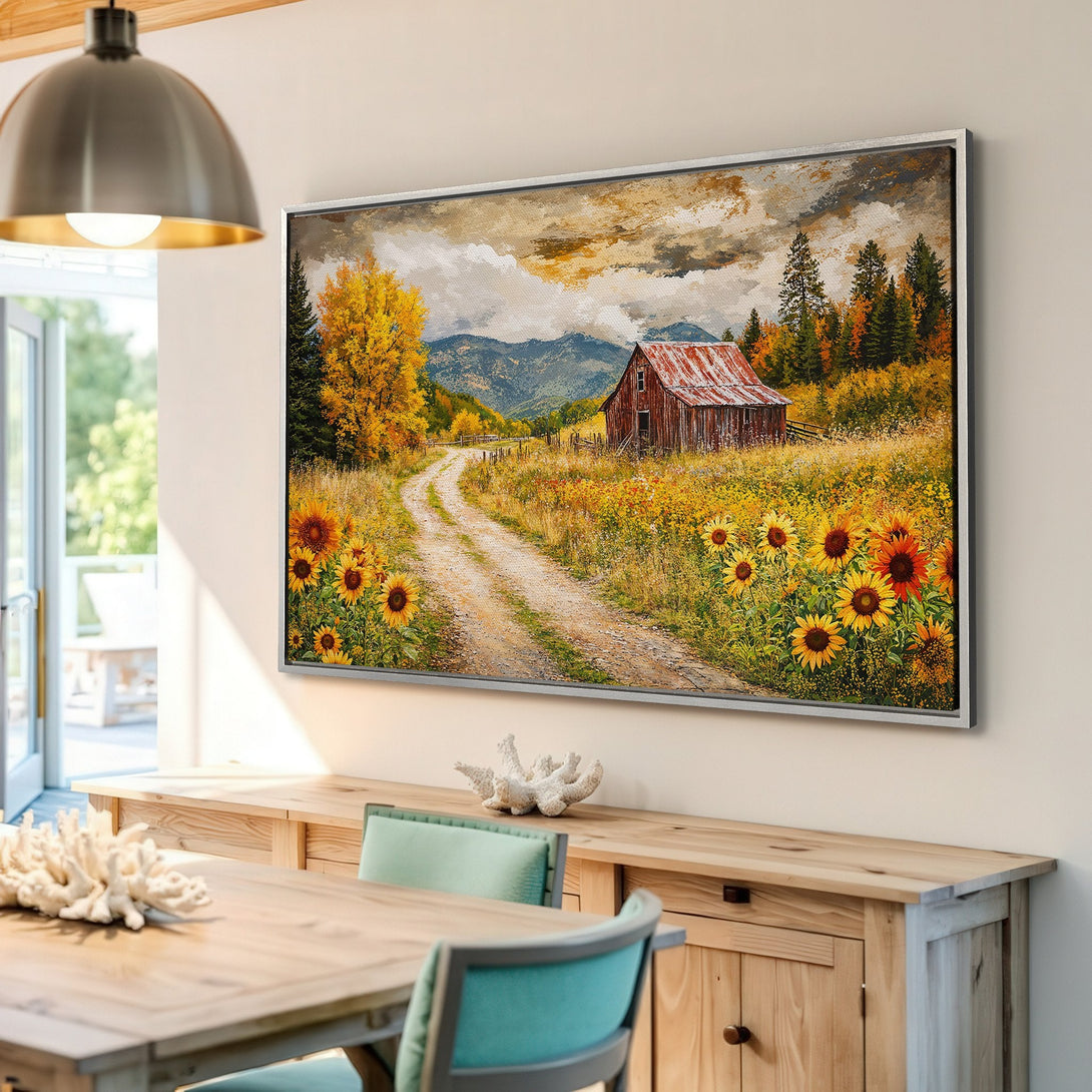 Framed Wall Art: Rustic barn scene canvas print with sunflowers, road, and fall colors. Perfect for farmhouse decor. Warm palette of yellows, oranges, and browns.
