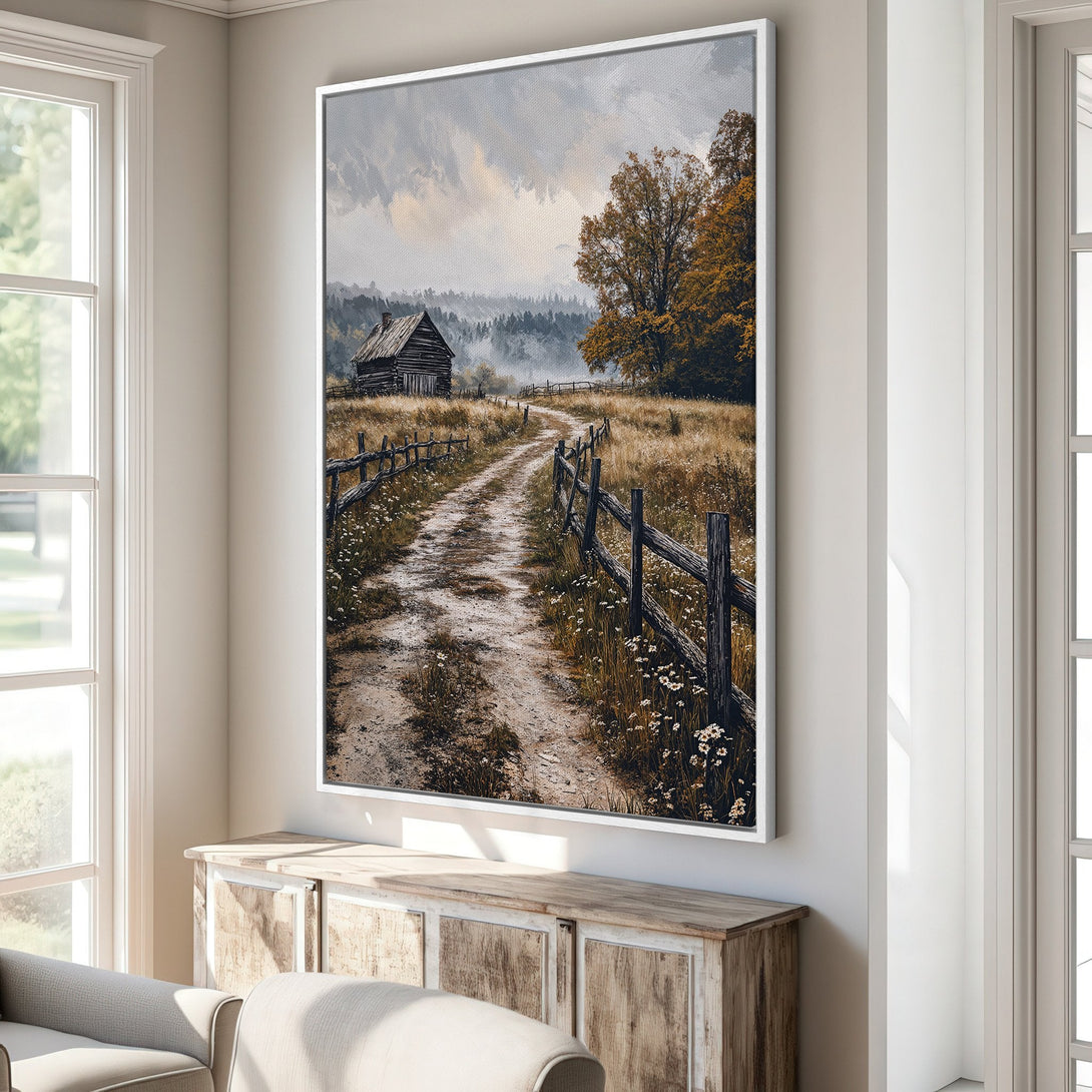 Framed Wall Art: Rustic landscape Canvas Print. Featuring a dirt road, cabin, and fall colors. Warm, earthy tones create a cozy, inviting atmosphere.