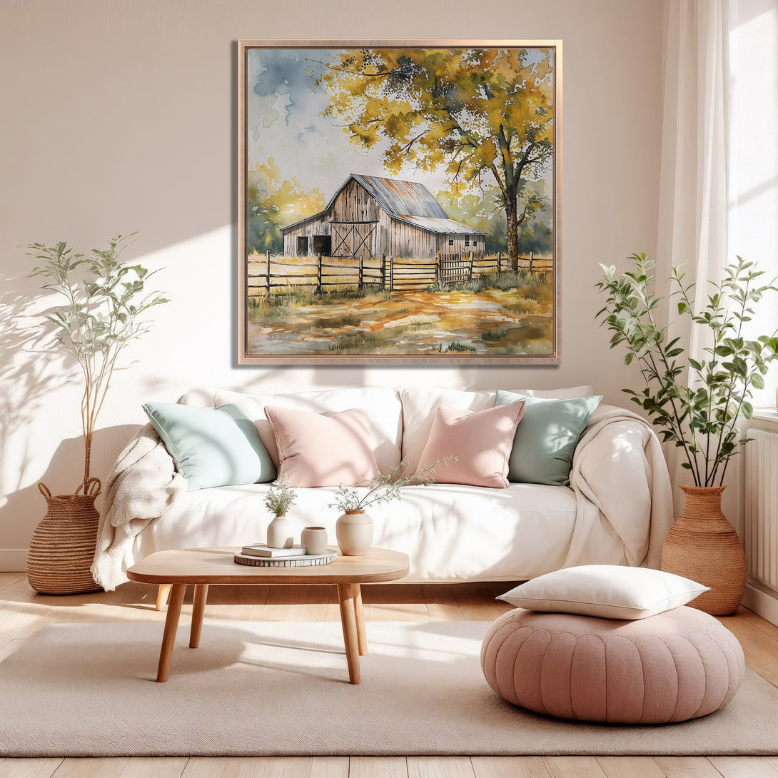Framed Wall Art Canvas Print of a rustic barn watercolor painting, warm yellow and neutral color palette, displayed in a cozy living room.