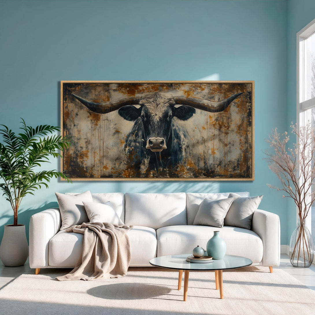 Framed Wall Art featuring a black and white bull in an abstract style with a warm, earthy color palette. Perfect for adding rustic charm to any space.