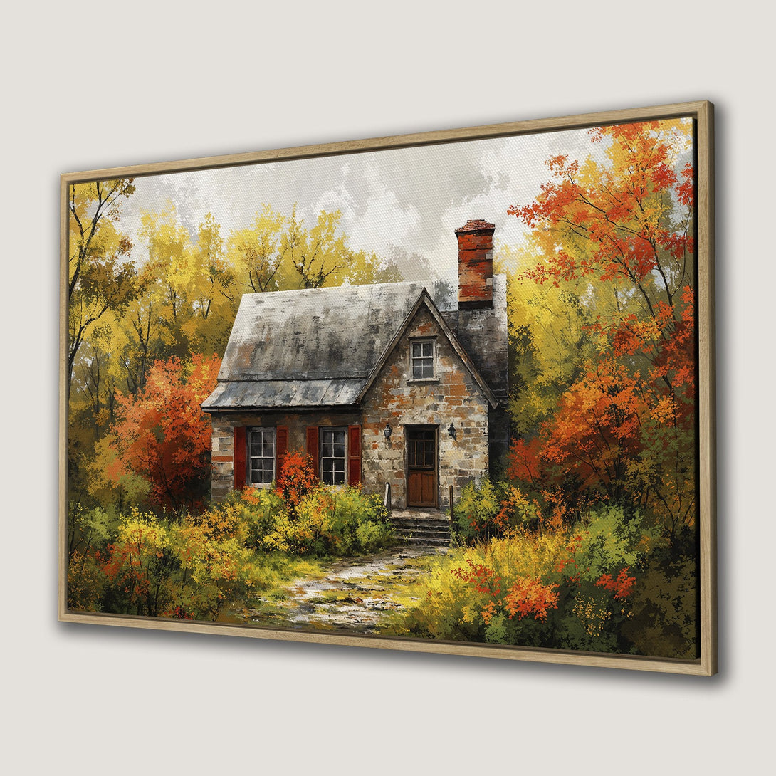 Framed Wall Art of a charming cottage in an autumn forest. Warm color palette of golds, oranges, and reds. Perfect for adding cozy vibes to your home.