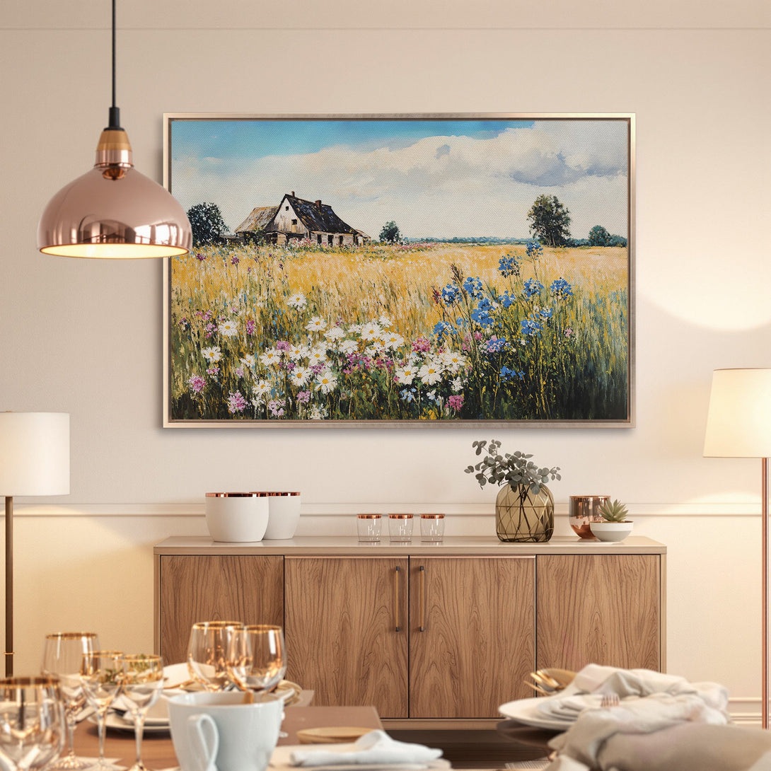 Framed Wall Art: Rustic landscape canvas print with a farmhouse and wildflowers. Warm yellow, blue, and green color palette. Perfect for home decor.