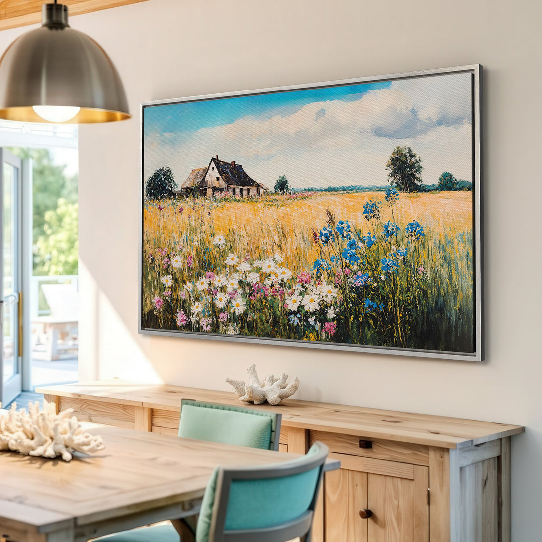 Framed Wall Art of a rustic farmhouse in a field of flowers. Impressionist style with warm yellow, blue, and green hues. Perfect for adding a touch of nature.