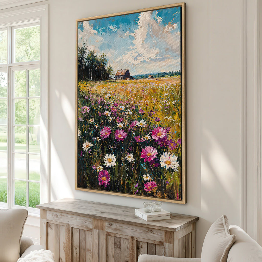 Framed Wall Art: Impressionist painting of a wildflower field with a barn, in a warm, inviting color palette of blues, yellows, pinks, and greens. Perfect for home decor.