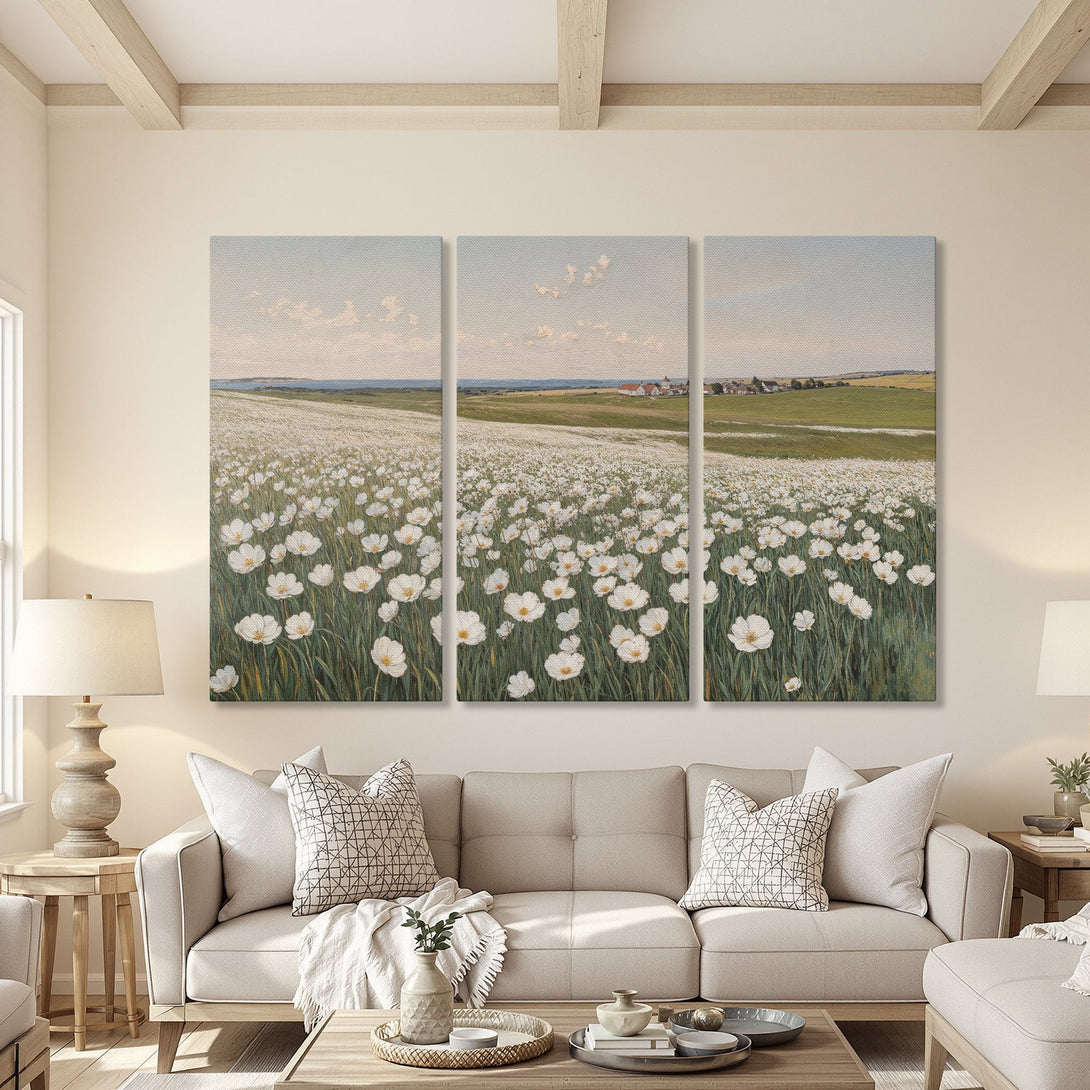 Canvas Print triptych featuring a field of white flowers in a serene, impressionistic style. Soft green, white, and blue color palette. Perfect wall decor!