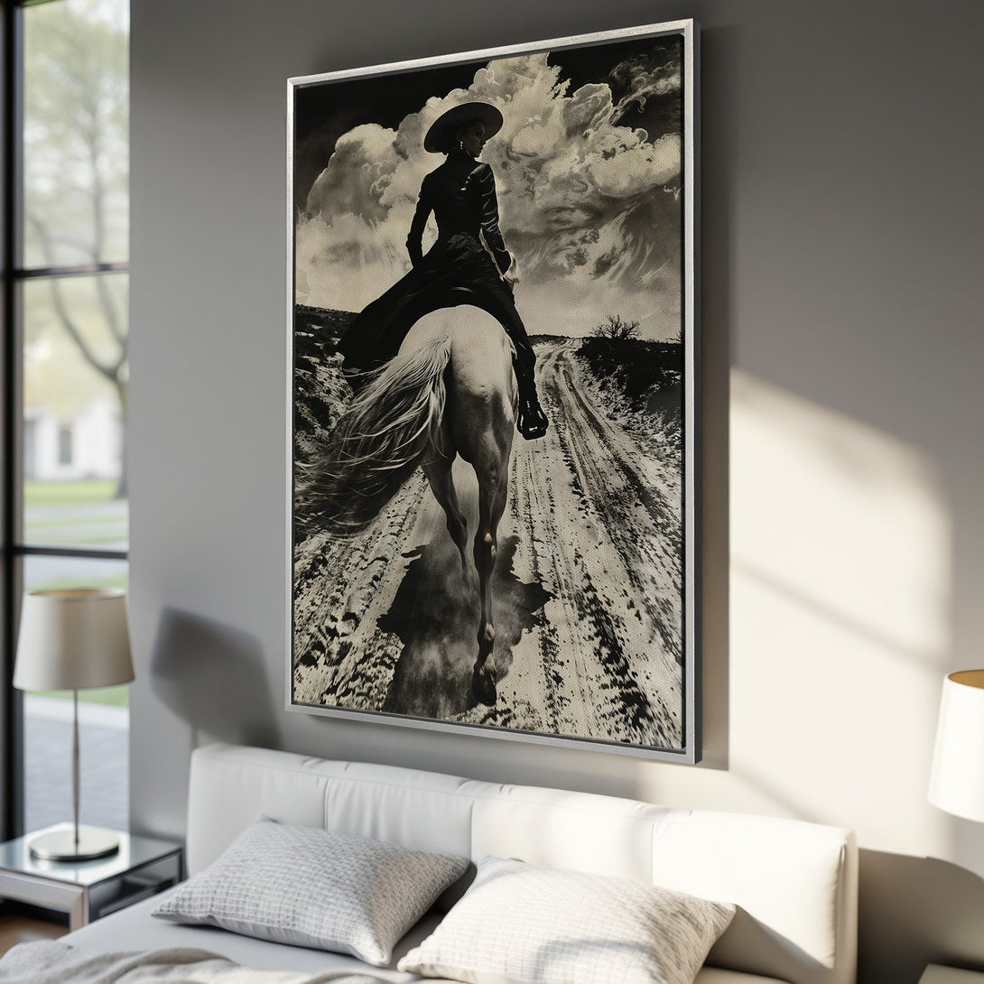 Framed Wall Art: Dramatic black & white canvas print of a cowgirl on horseback. Rustic, vintage style with a neutral color palette, perfect for any room.