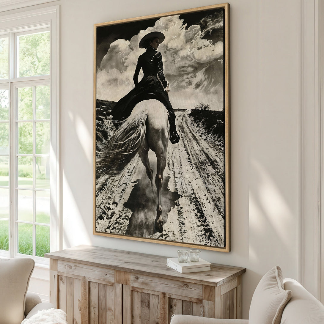 Framed Wall Art: Dramatic black and white canvas print of a cowgirl riding a white horse. Adds a touch of western elegance to any space.