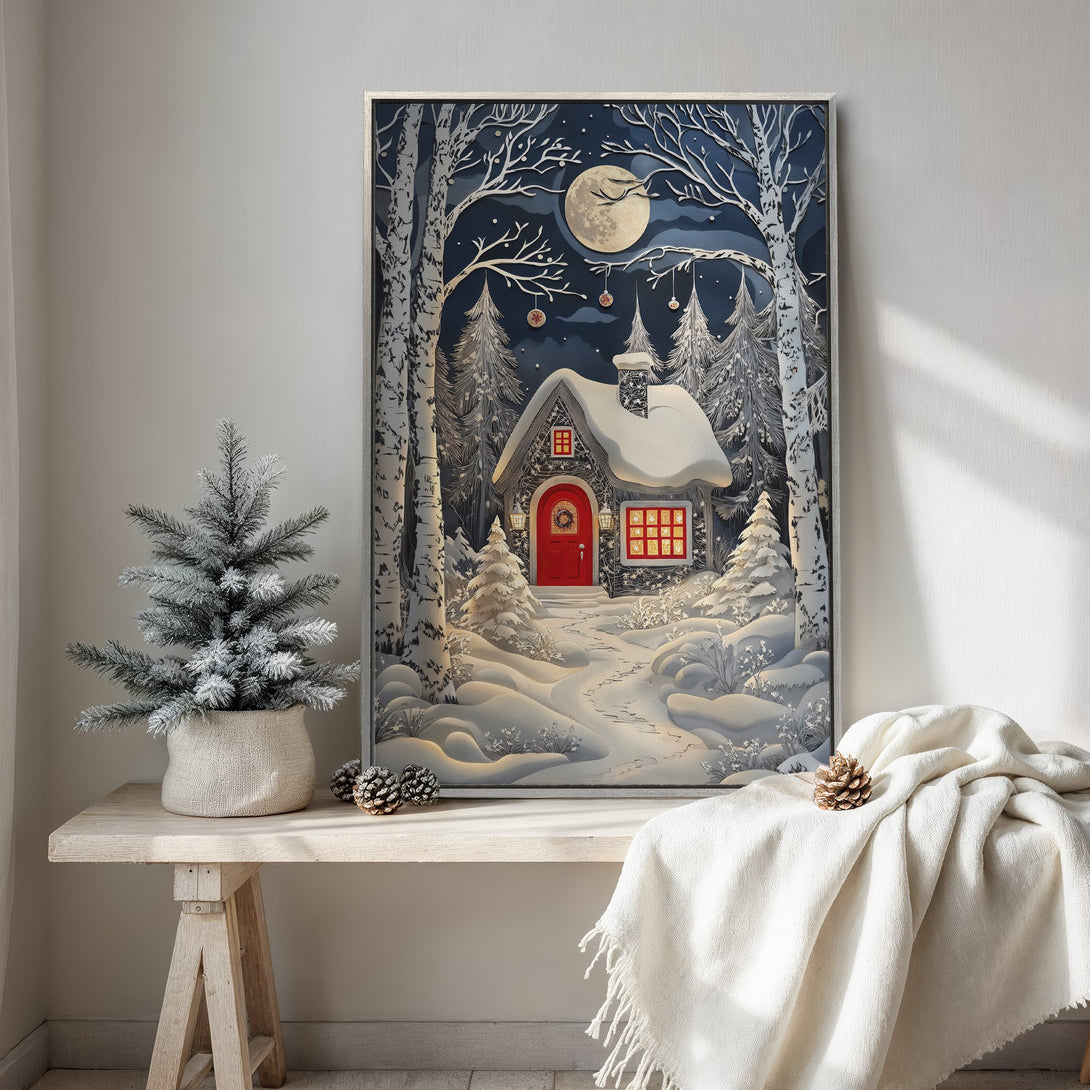 Framed Wall Art: Winter cabin scene in a paper-cut style. Features a cozy red door and snowy landscape. Blue, white, and red color palette. Perfect holiday decor.