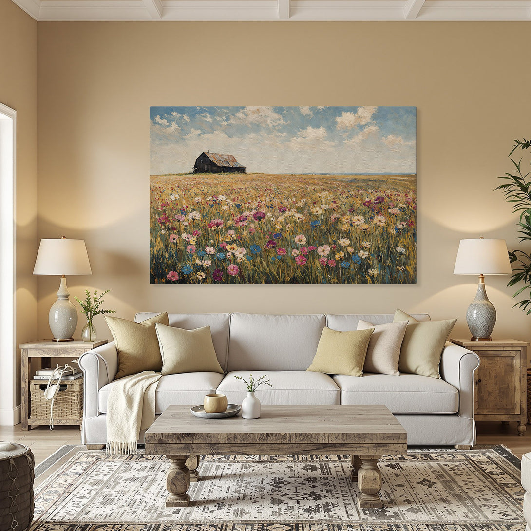 Framed Wall Art of a vibrant wildflower field with a rustic barn, displayed in a warm-toned interior. Beautiful landscape art with colorful palette.