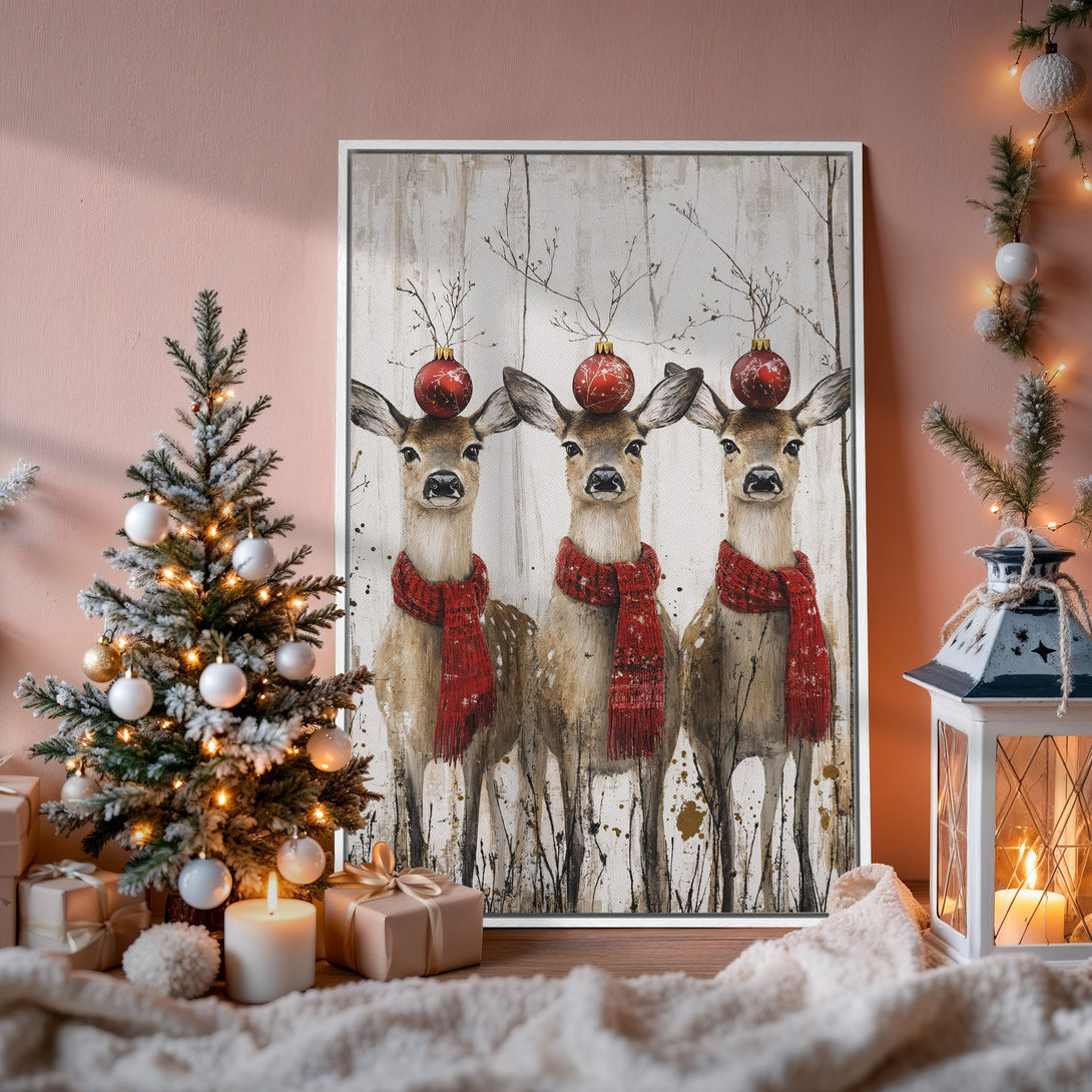 Framed Wall Art featuring festive deer with red scarves & ornaments. Rustic style, warm neutral & red color palette, perfect holiday decor.