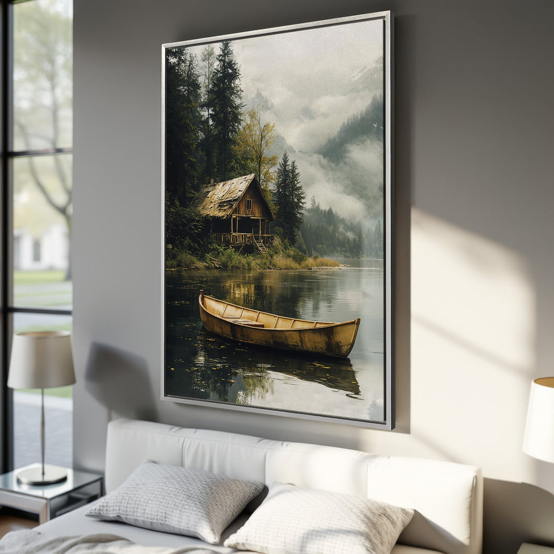 Framed Wall Art: Serene lake scene Canvas Print. Rustic cabin, yellow boat, and misty mountains in a calming green, brown, and gray palette. Perfect for your home!