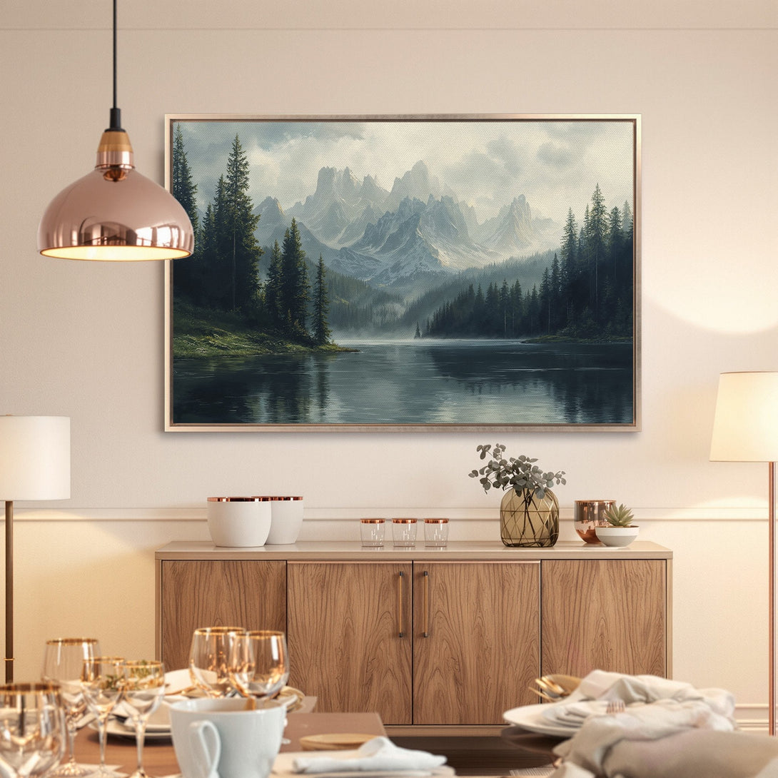 Framed Wall Art featuring a serene mountain lake landscape in muted blues and greens. Perfect for adding a touch of nature to your home.