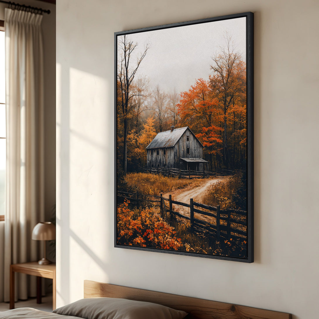 Framed Wall Art featuring a rustic barn in an autumn forest. Warm orange and brown tones create a cozy, inviting atmosphere. Perfect for adding a touch of nature to your space.