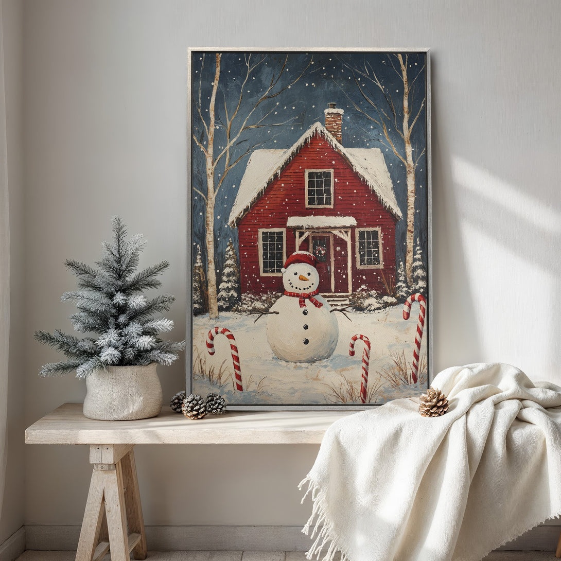 Framed Wall Art: Winter scene with a red house and snowman. Rustic style, blue, red, and white color palette. Perfect holiday decor for your home.