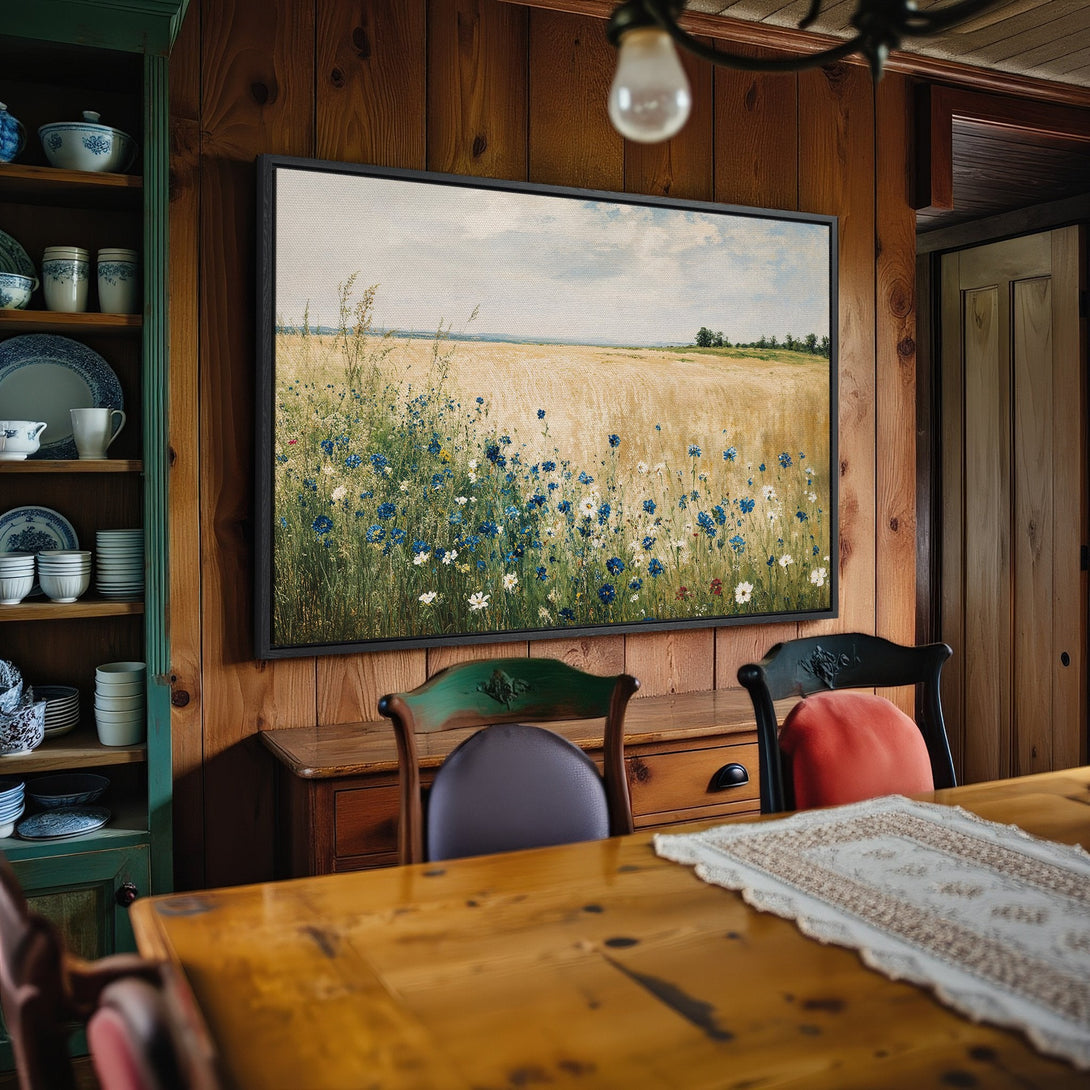Framed Wall Art: Field of wildflowers canvas print in a rustic interior. Features a warm, natural color palette with blues, greens, and golds. Perfect home decor.