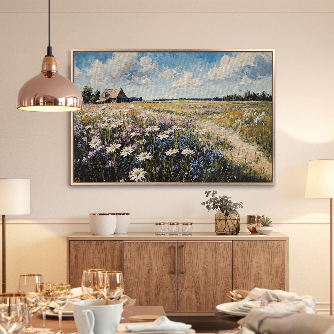 Framed Wall Art: Impressionist landscape painting with wildflowers, blue sky, and rustic barn. Warm, inviting color palette for your home decor.