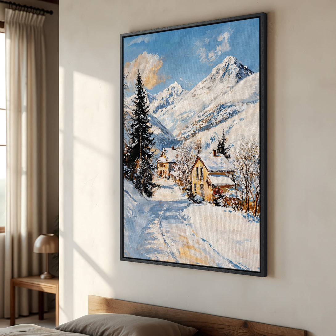 Framed Wall Art: Winter landscape canvas print with snow-covered mountains, cozy cabins, and a serene blue & white color palette. Add warmth to your home!