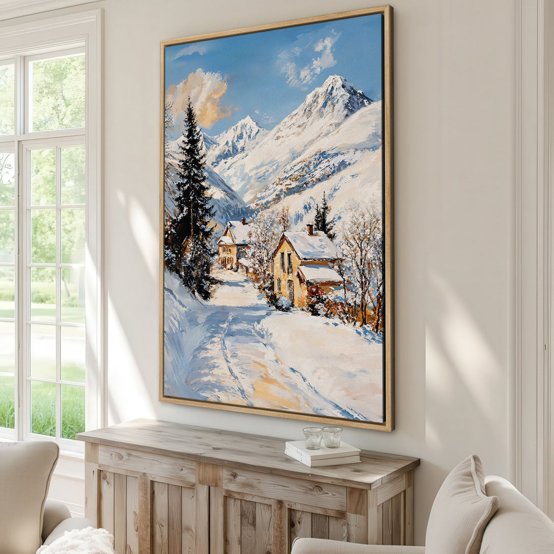 Framed Wall Art: Winter landscape painting with snowy mountains and quaint houses, showcasing a serene blue, white, and yellow color palette. Perfect for home decor.