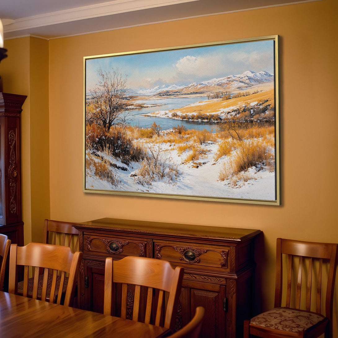 Canvas Print of a winter landscape painting in a neutral-toned interior. Featuring a snow-covered scene with blue, white, and golden hues.