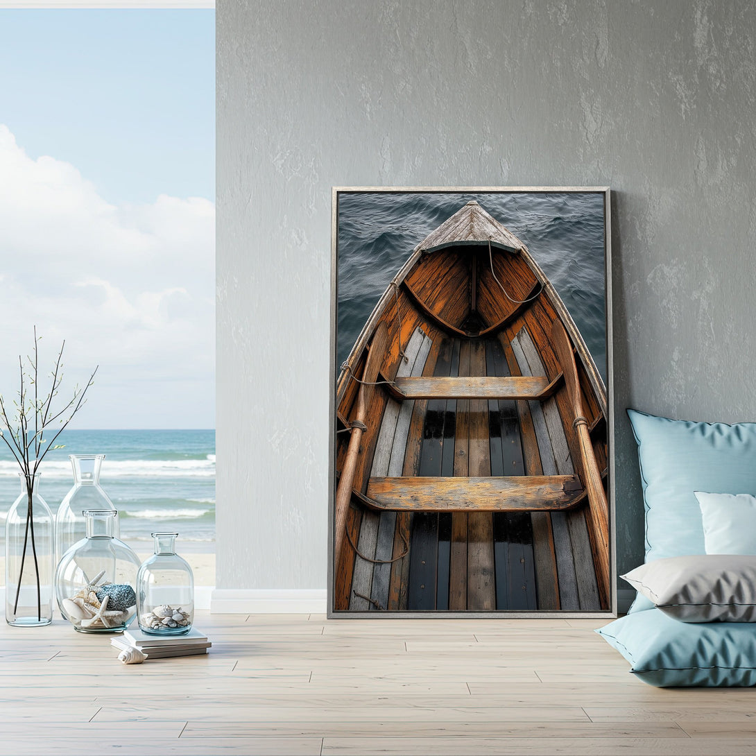 Framed Wall Art of a weathered wooden boat on the water. Coastal decor with a warm, rustic aesthetic and a soothing blue and brown color palette.