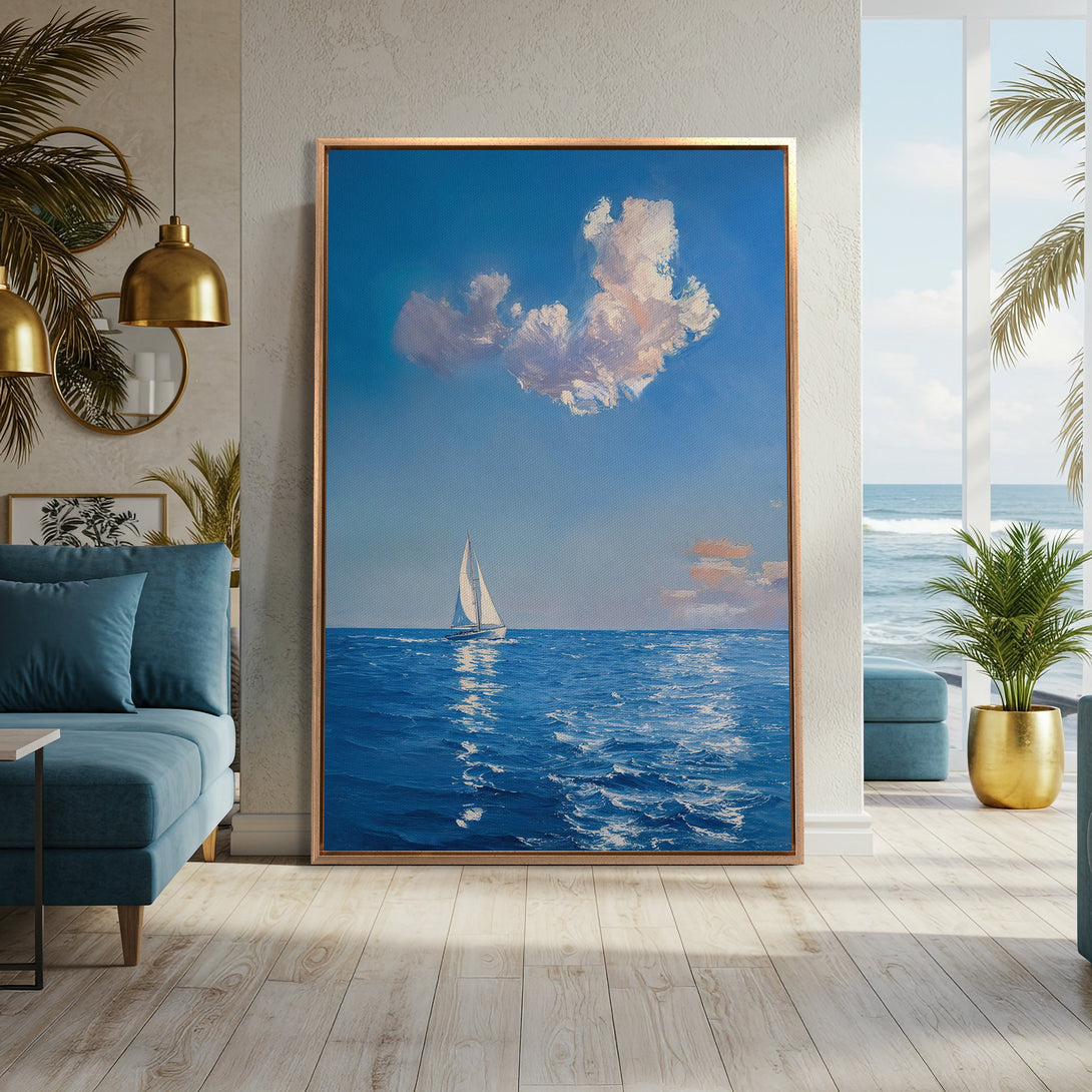 Framed Wall Art of a sailboat on the ocean, rendered in a serene blue and white palette. Coastal art perfect for any home.
