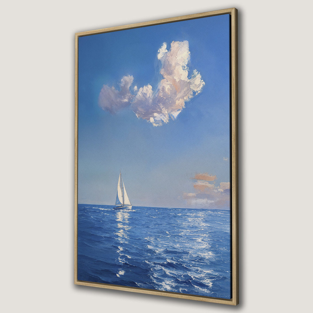 Framed Wall Art: Serene seascape Canvas Print featuring a sailboat under a blue sky with fluffy clouds. Coastal art in calming blue and white tones.