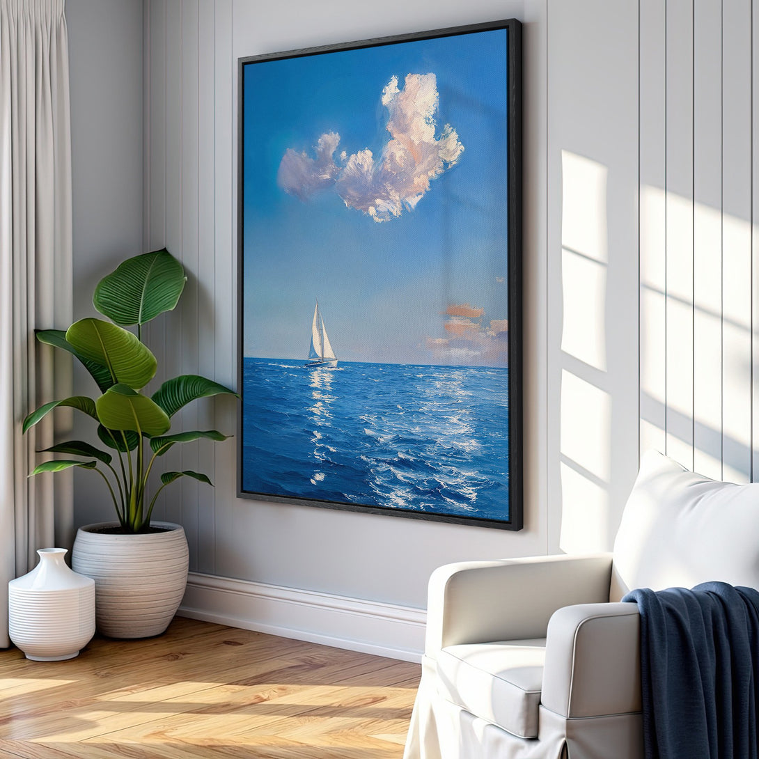 Framed Wall Art of a sailboat on the ocean, in a serene blue and white color palette. Perfect coastal decor to brighten any space.