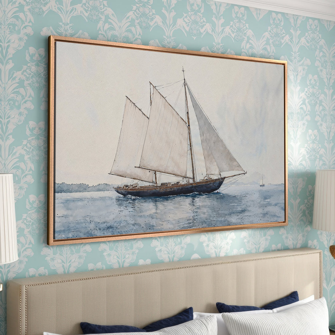 Framed Wall Art: Watercolor sailboat print in a gold frame. Soft blue and neutral tones create a serene, coastal aesthetic perfect for bedroom decor.