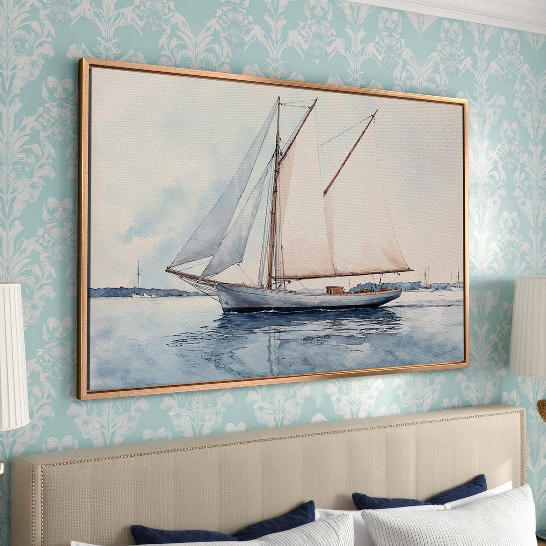 Framed Wall Art: Watercolor sailboat print in a gold frame. Coastal style art with blue, white, and beige color palette. Perfect for bedroom decor.