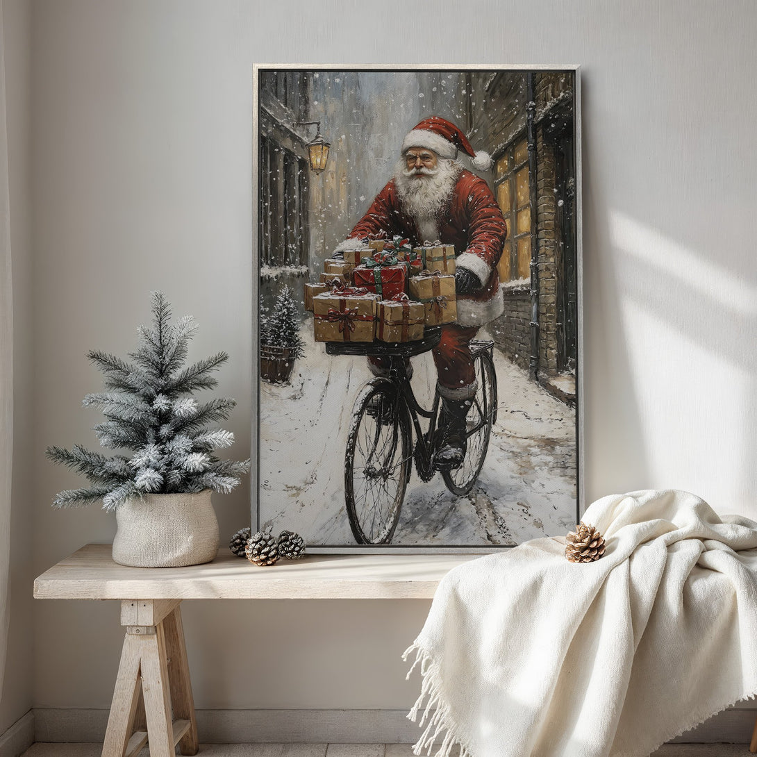 Framed Wall Art: Santa Claus on a bicycle delivering gifts. Festive painting with a vintage style and warm red and snowy blue tones. Perfect Christmas decor!