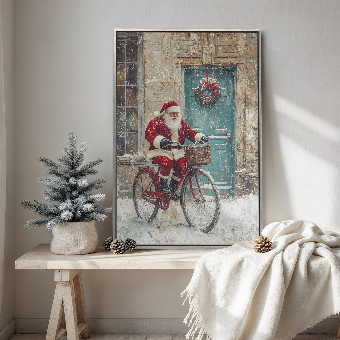 Framed Wall Art: Santa Claus on a bicycle in a snowy scene. Rustic, warm colors with a touch of teal. Perfect Christmas decor!
